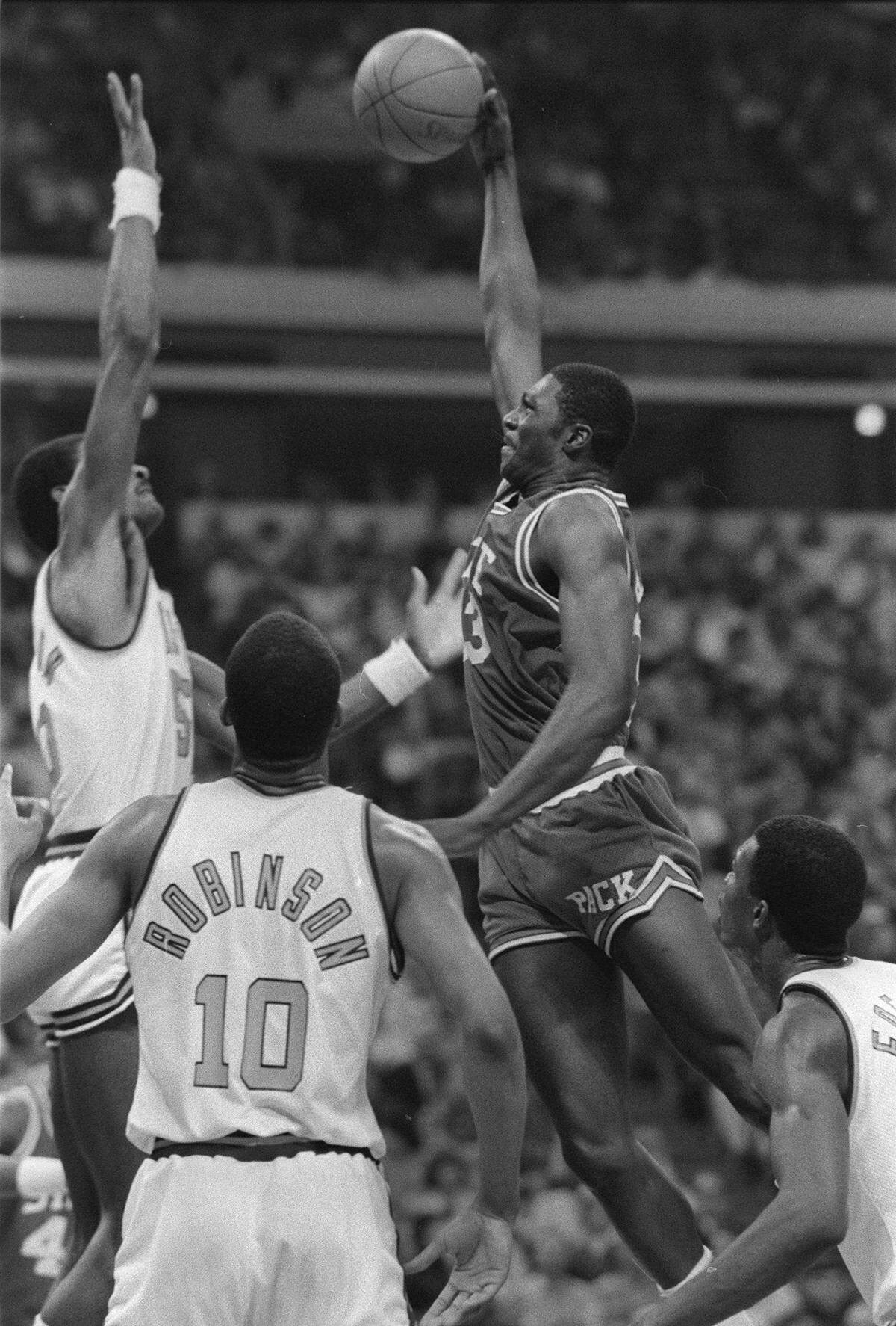N.C. State’s Alvin Battle drives to the basket against Virginia’s Ralph Sampson. The Wolfpack won the championship 81-78.