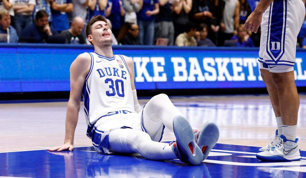 Duke’s Kyle Filipowski (30) sits on the court after he was injured during the second half of Duke’s 80-56 victory over Charlotte at Cameron Indoor Stadium in Durham, N.C., Saturday, Dec. 9, 2023. Filipowski returned a little bit later in the game.