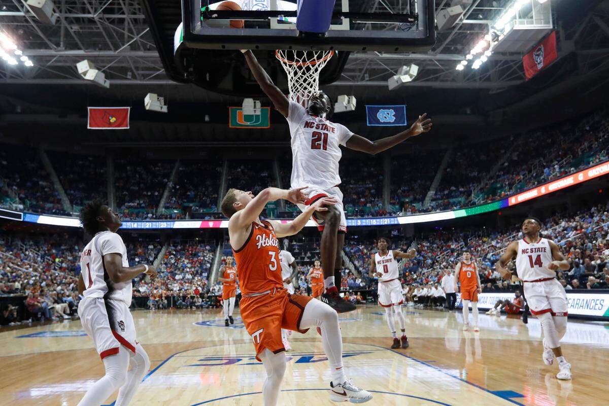 N.C. State’s Ebenezer Dowuona (21) blocks the shot by Virginia Tech’s Sean Pedulla (3) during N.C. State’s 97-77 victory over Virginia Tech in the second round of the ACC Men’s Basketball Tournament in Greensboro, N.C., Wednesday, March 8, 2023.