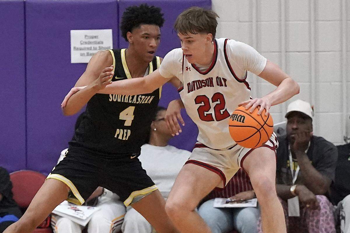 Davidson Day's William Stevens (22) posts up against Southeastern Prep's CJ Rosser Jr. (4) during the first half. The Davidson Day Patriots and the Southeastern Prep Academy National Falcons met in the John Wall Holiday Tournament in Raleigh, N.C. on December 27, 2025.