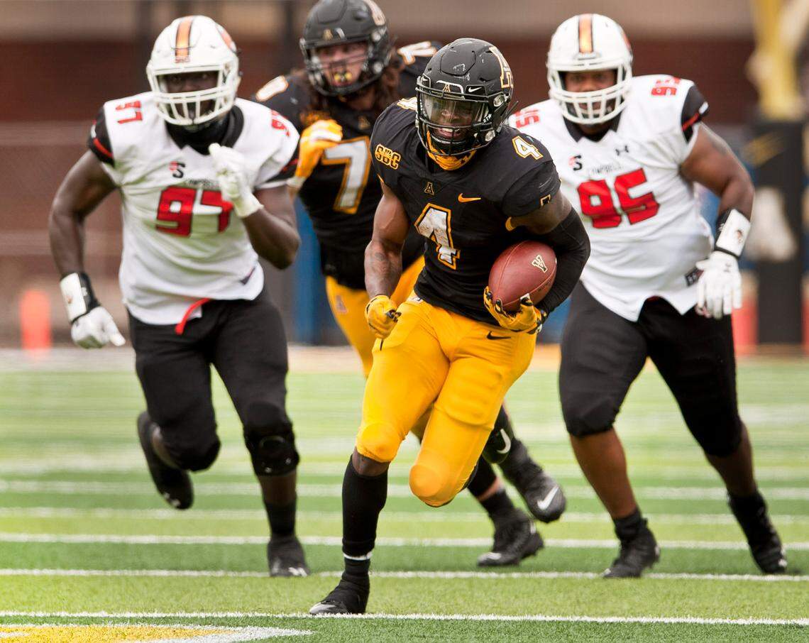 Appalachian State running back Daetrich Harrington finds a hole in the Campbell defense to break loose for a 40 yard touchdown run during the second half an NCAA college football game, Saturday, Sept. 26, 2020 at Kidd Brewer Stadium in Boone, N.C. (Walt Unks/The Winston-Salem Journal via AP)