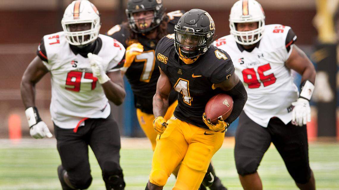 Appalachian State running back Daetrich Harrington finds a hole in the Campbell defense to break loose for a 40 yard touchdown run during the second half an NCAA college football game, Saturday, Sept. 26, 2020 at Kidd Brewer Stadium in Boone, N.C. (Walt Unks/The Winston-Salem Journal via AP)