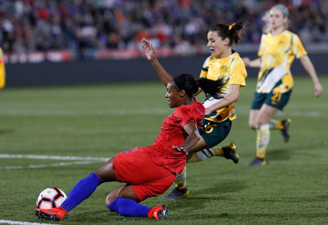 United States defender Crystal Dunn, front, fires the ball past Australia forward Hayley Raso during the second half of an international friendly soccer match Thursday, April 4, 2019, in Commerce City, Colo. The United States won 5-3. (AP Photo/David Zalubowski)