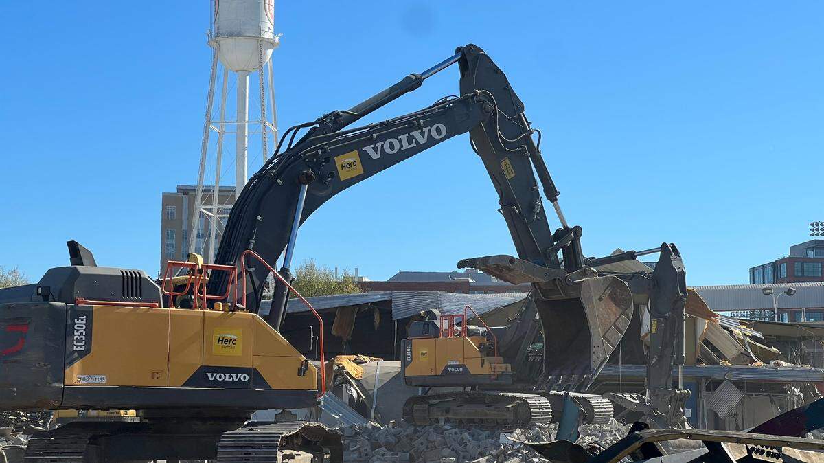 Crews began razing the former University Ford property at 601 Willard Street, paving way for the planned expansion of the American Tobacco Campus.