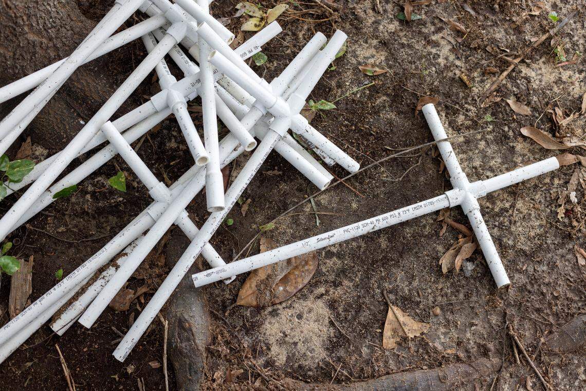 Simple crosses of PVC pipe are used to mark grave sites in the historic Wilkins Cemetery on Wednesday, August 24, 2022 in Dunn, N.C. Martin Williams cut and glued each cross together by hand.