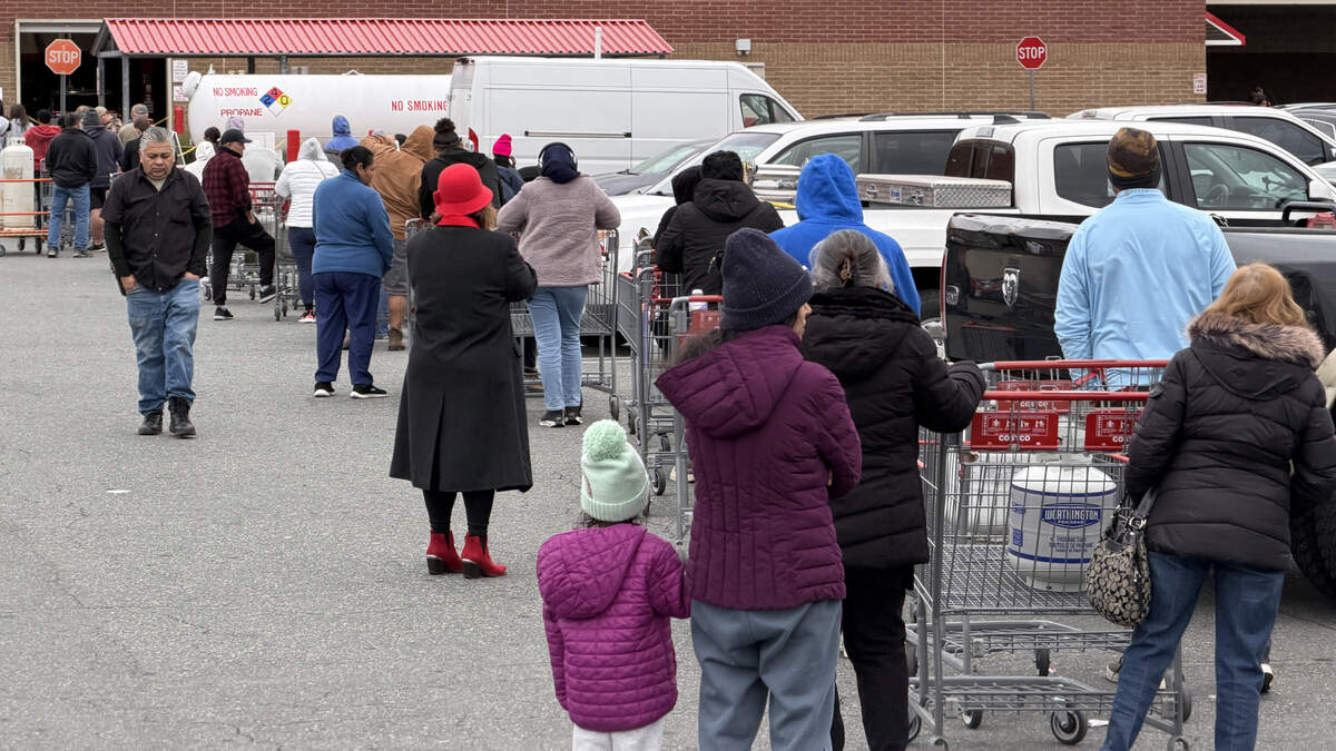 Customers wait in line to refill their propane tanks at the Raleigh Costco Friday afternoon in advance of a major winter storm that will hit Saturday and Sunday.
