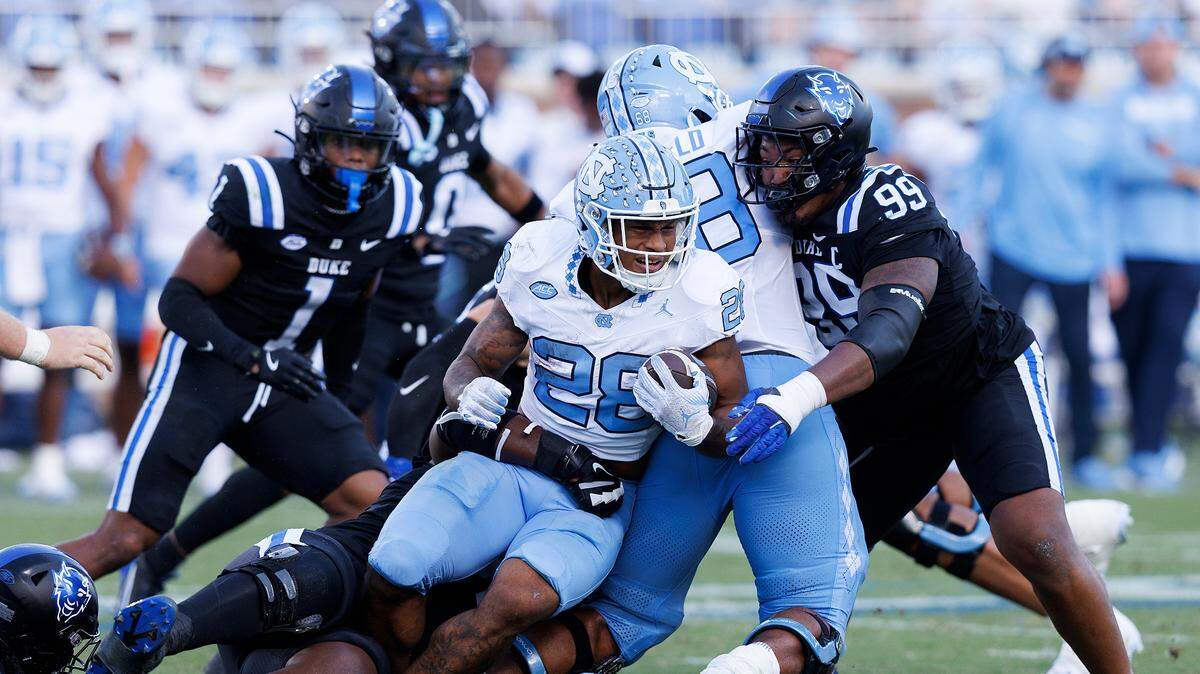 North Carolina’s Omarion Hampton is brought down by Duke’s Kendy Charles during the first half of the Tar Heels’ 21-20 loss on Saturday, Sept. 28, 2024, at Wallace Wade Stadium in Durham, N.C.