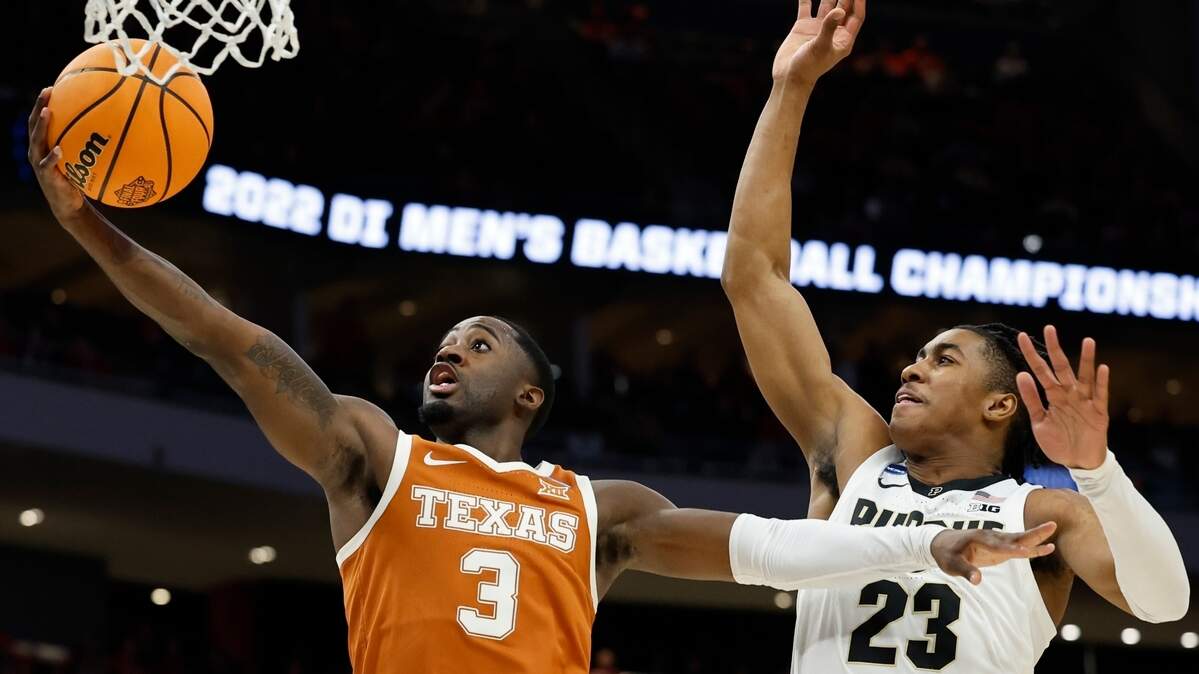 Texas’s Courtney Ramey shoots past Purdue’s Jaden Ivey during the first half of a second-round NCAA college basketball tournament game Sunday, March 20, 2022, in Milwaukee.