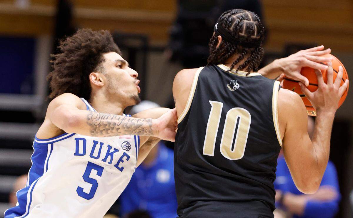 Duke’s Tyrese Proctor (5) pressures Wofford’s Corey Tripp (10) during the second half of Duke’s 86-35 victory over Wofford at Cameron Indoor Stadium in Durham, N.C., Saturday, Nov. 16, 2024.