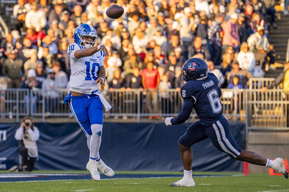 Duke’s Darian Mensah (10) passes while being pursued by UConn’s Bryun Parham during the first half November 08, 2025 in East Hartford, Connecticut. 