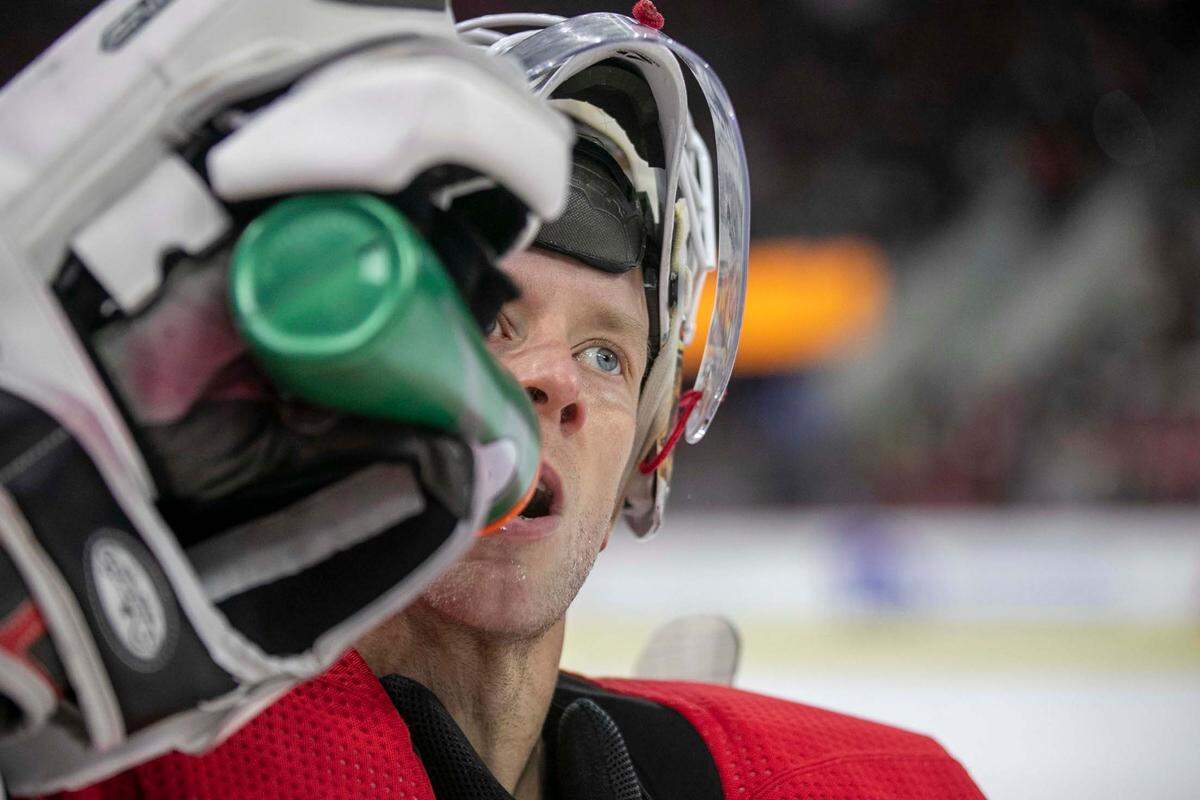 Carolina Hurricanes’ goalie Antii Raanta (32) hydrates during a time-out against the Senators on Thursday, December 2, 2021 at PNC Arena in Raleigh, N.C.