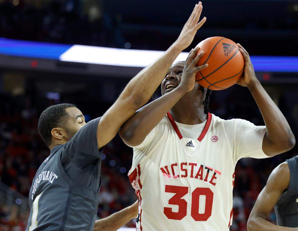 North Carolina State’s D.J. Burns Jr. looks to shoot over Georgia Tech’s Kyle Sturdivant during the first half of a men’s basketball game at PNC Arena on Saturday, Feb. 4, 2023, in Raleigh, N.C.