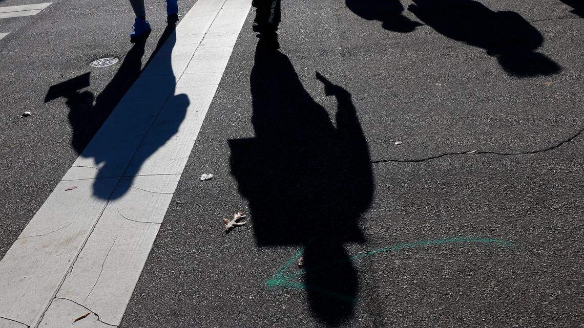 People cross Jones Street while marching around the Executive Mansion as a part of the Vigil for Freedom and Racial Justice on Thursday, Dec. 1, 2022, in Raleigh, N.C. Community advocates will hold vigil daily outside the Executive Mansion throughout the month of December to call for justice and fair treatment of people incarcerated in North Carolina prisons.
