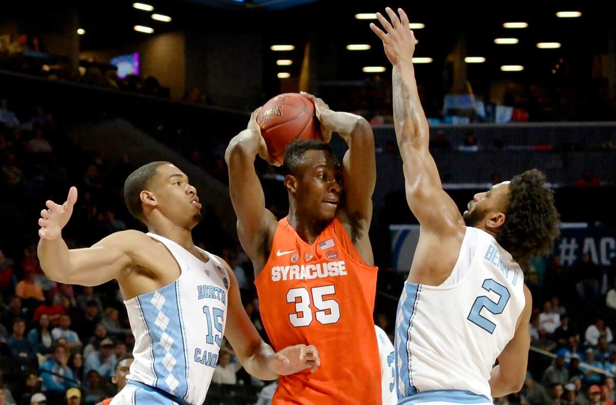 UNC forward Garrison Brooks (15) and teammate guard Joel Berry II (2) double team Syracuse forward Bourama Sidibe (35) in the second half. UNC defeated Syracuse 78-59 to advance to the Quarter Finals of the ACC  Tournament.