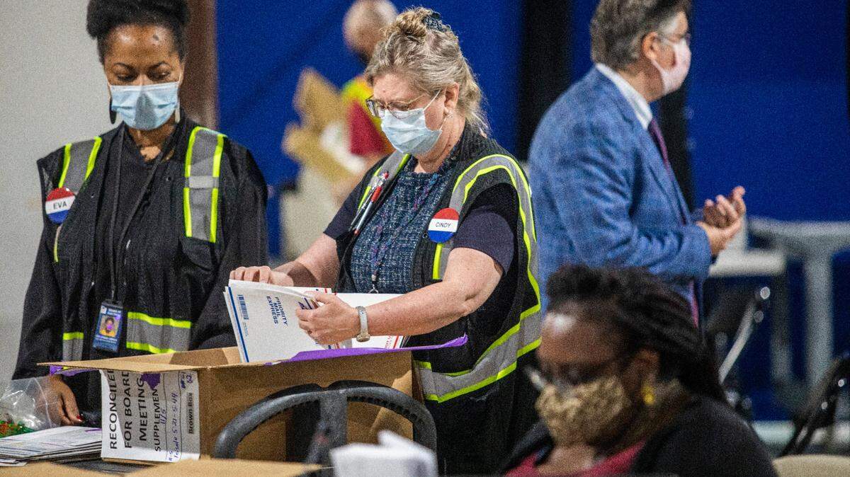 Election workers process absentee ballots at the Wake County Board of Elections Operations Center in Raleigh in this file photo from November 2020.