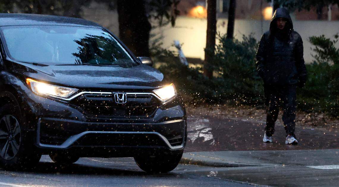 Headlights illuminate the sleet as it falls on Dunn Ave. on the campus of N.C. State in Raleigh, N.C., Friday, Jan. 10, 2025.