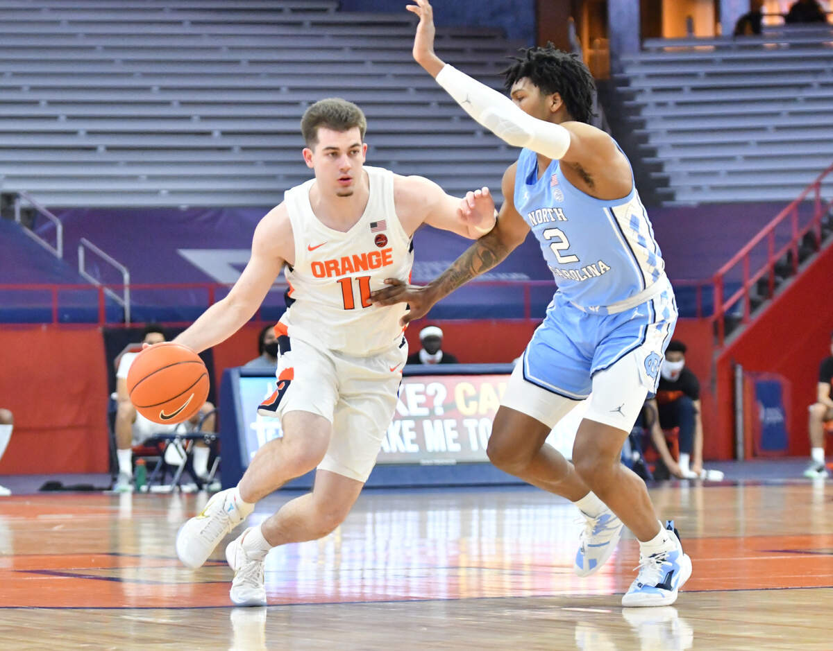 Syracuse Orange guard Joseph Girard III (11) moves the ball as North Carolina Tar Heels guard Caleb Love (2) defends in the first half at the Carrier Dome.