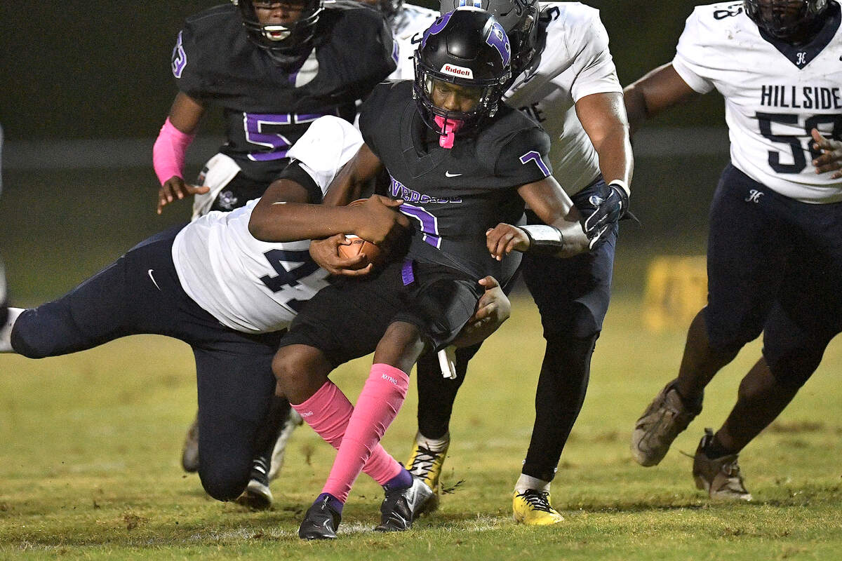 Hillside defensive end Khaleel Jackson (47) grapples Riverside quarterback Tre Belcher (7) and forces the fumble during the first half. The Durham Hillside Hornets and the Durham-Riverside Pirates met in a football game in Durham. N.C. on October 4, 2024.