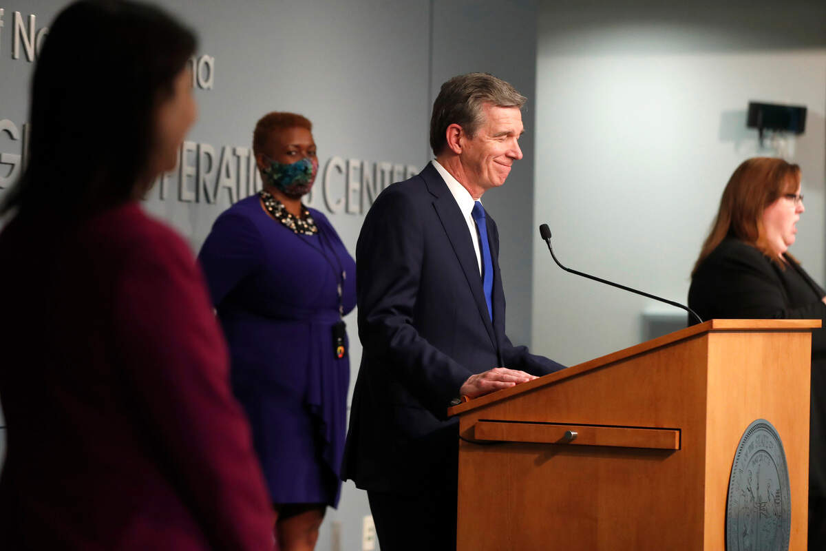 North Carolina Gov. Roy Cooper smiles at a question during a briefing at the Emergency Operations Center in Raleigh, N.C., Thursday, June 4, 2020.