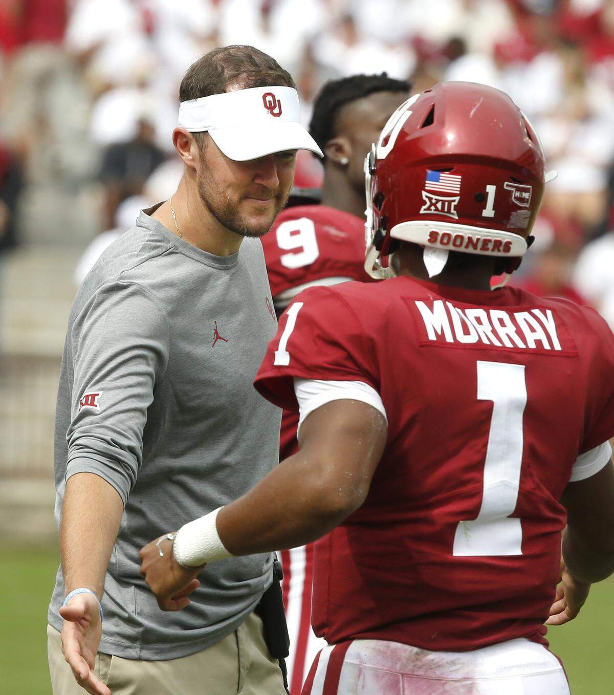 Oklahoma head coach Lincoln Riley, left, greets quarterback Kyler Murray (1) as he comes back to the sidelines following a touchdown in the second half of an NCAA college football game against UCLA in Norman, Okla., Saturday, Sept. 8, 2018. Oklahoma won 49-21.