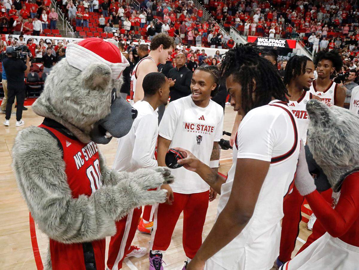 N.C. State’s Dennis Parker Jr. admires Mr. Wuf’s ring during a banner ceremony to commemorate the Wolfpack’s 2024 NCAA Tournament Final Four appearance and ACC Tournament championship on Monday, Nov. 4, 2024, at Lenovo Center in Raleigh, N.C.