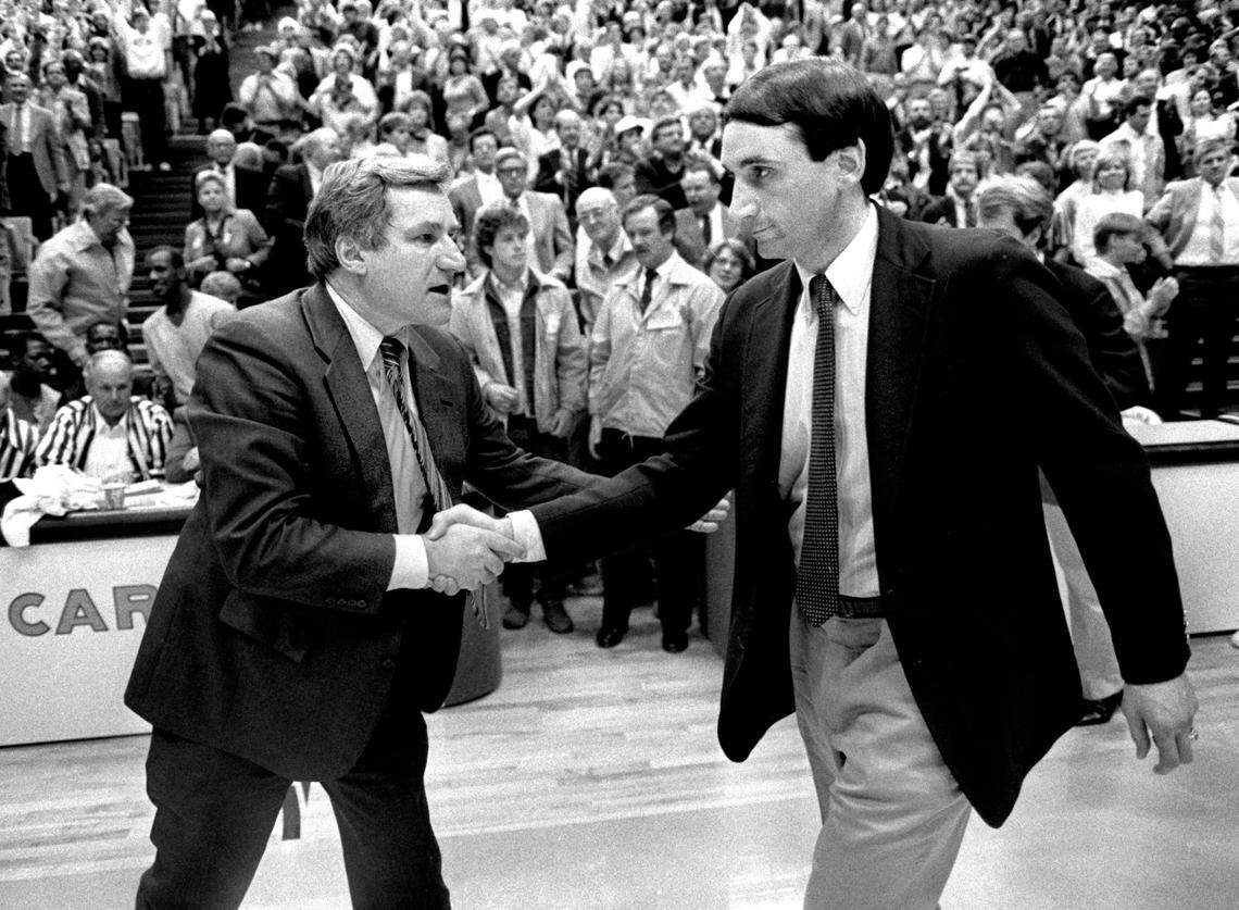 Dean Smith, left, shakes hands with Mike Krzyzewski after North Carolina defeated Duke in the first basketball game in the Smith Center on Jan, 18, 1986.