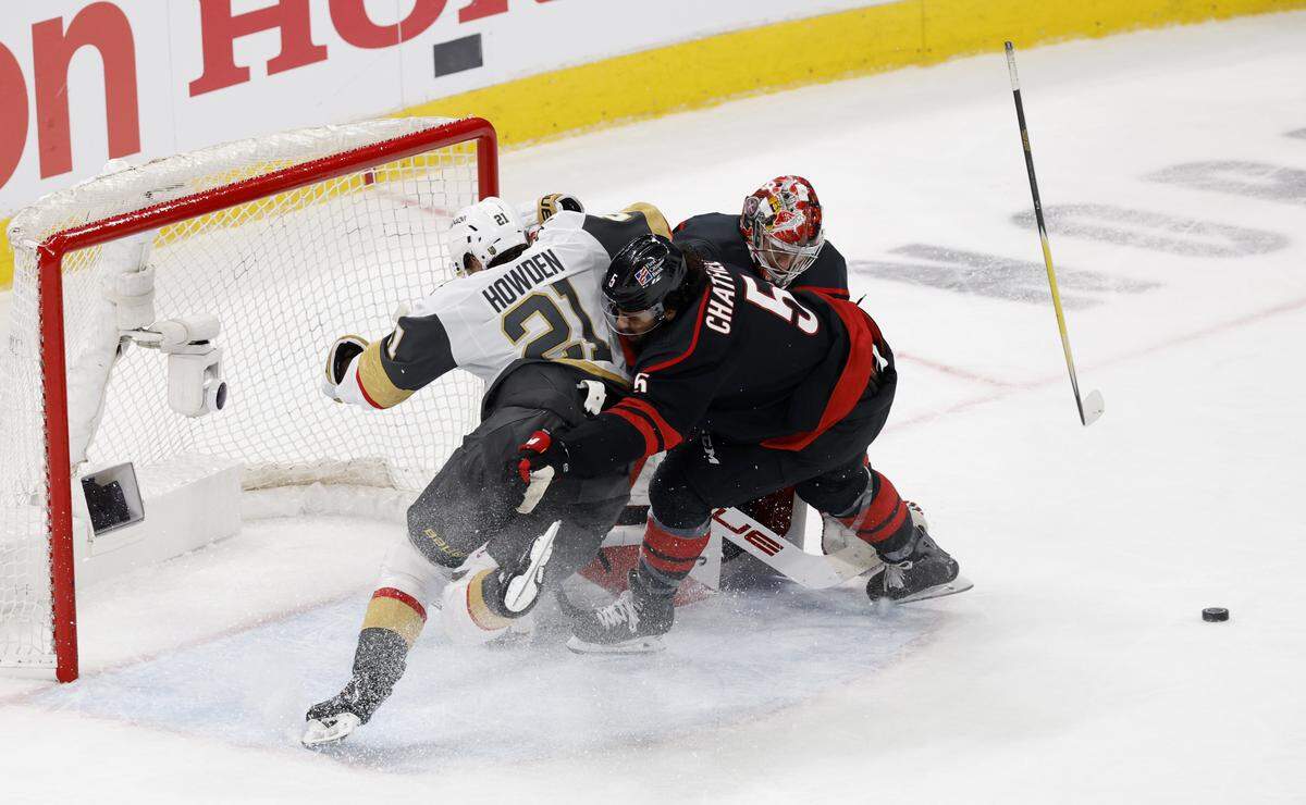 Carolina's Jalen Chatfield (5) pushes Vegas’ Brett Howden (21) away from the goal in the second period of the Hurricanes’ game against the Golden Knights in the second game of the Stanley Cup Final at the Lenovo Center in Raleigh, N.C., Thursday, June 4, 2026.