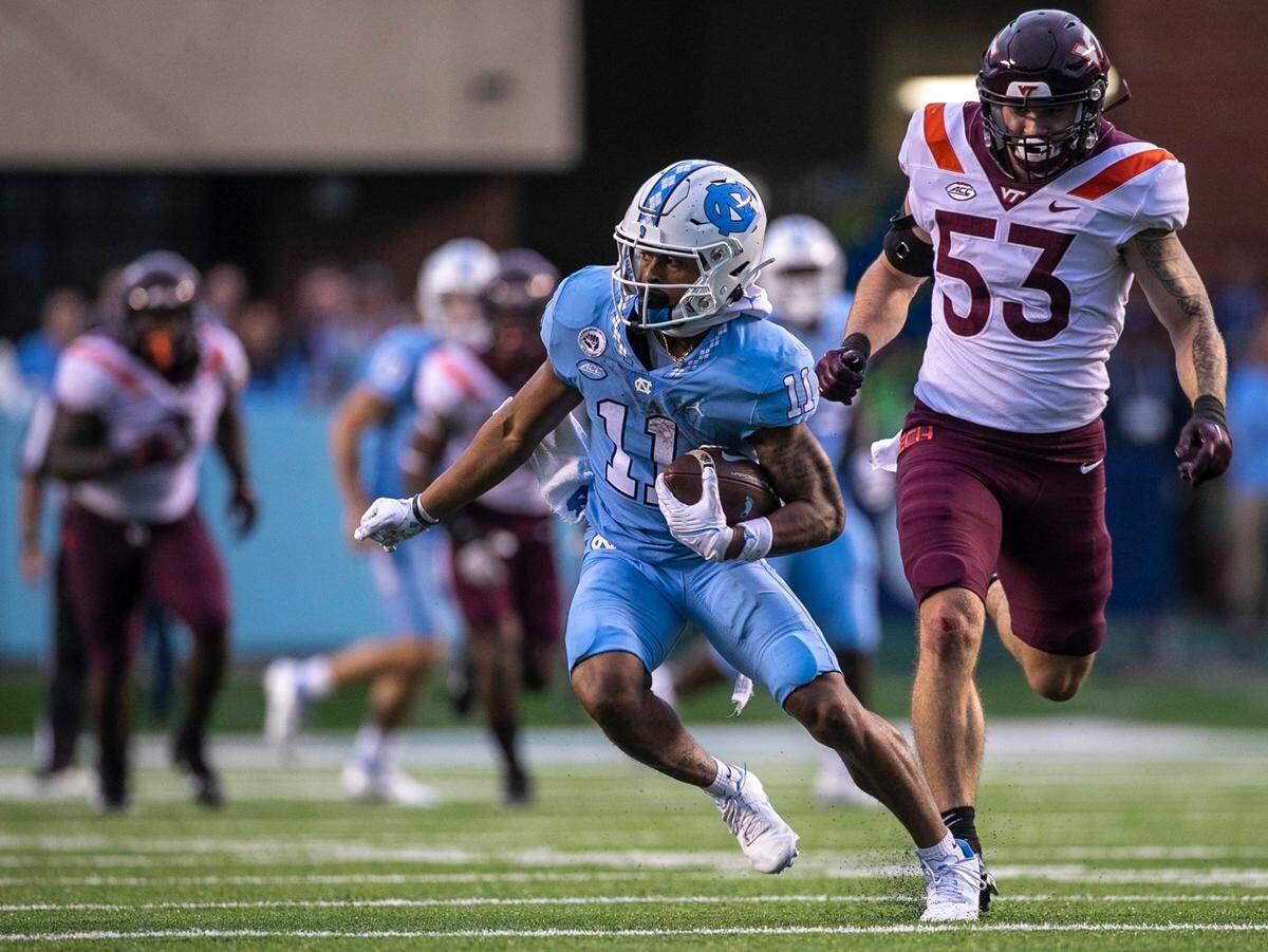 North Carolina wide receiver Josh Downs (11) picks up 33-yard on a pass completion from quarterback Drake Maye in the third quarter ahead of Virginia Tech’s Will Johnson (53) on Saturday, October 1, 2022 at Kenan Stadium in Chapel Hill, N.C.