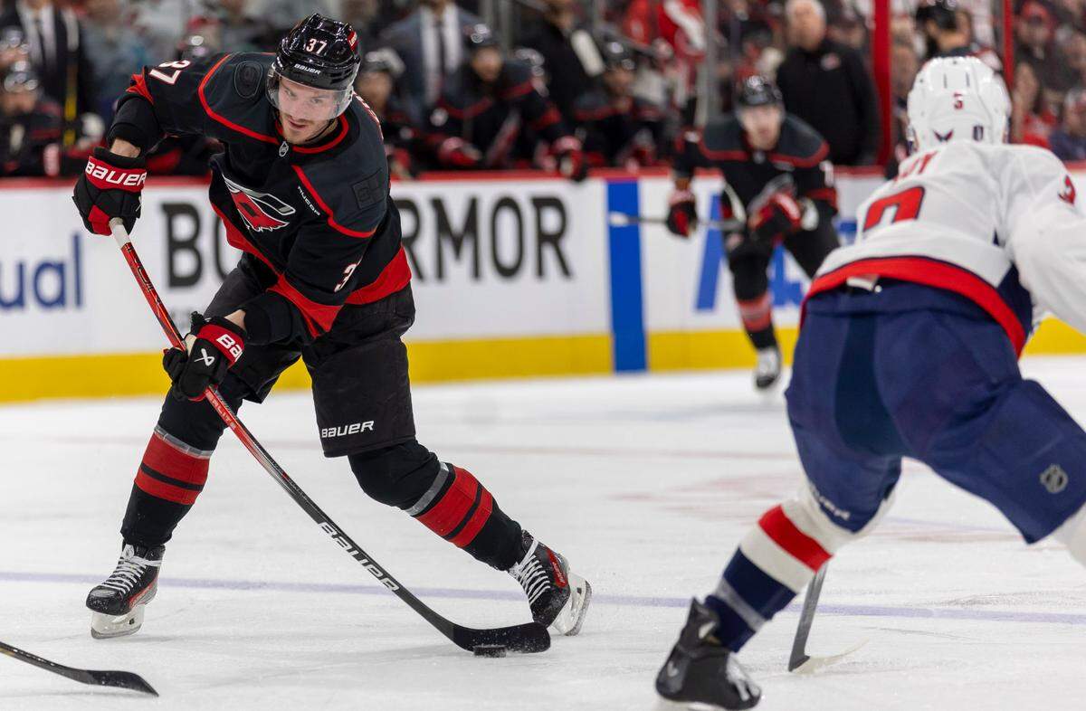 Carolina Hurricanes right wing Andrei Svechnikov (37) skates against Washington Capitals defenseman Matt Roy in the first period during Game 3 of their series on Saturday, May 10, 2025 at Lenovo Center in Raleigh, N.C.