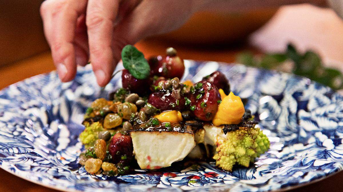 A plate of roasted cauliflower with sweet potato, caper, date, pine nut and grape at Littler in Durham is photographed on Thursday, Feb. 24, 2022.