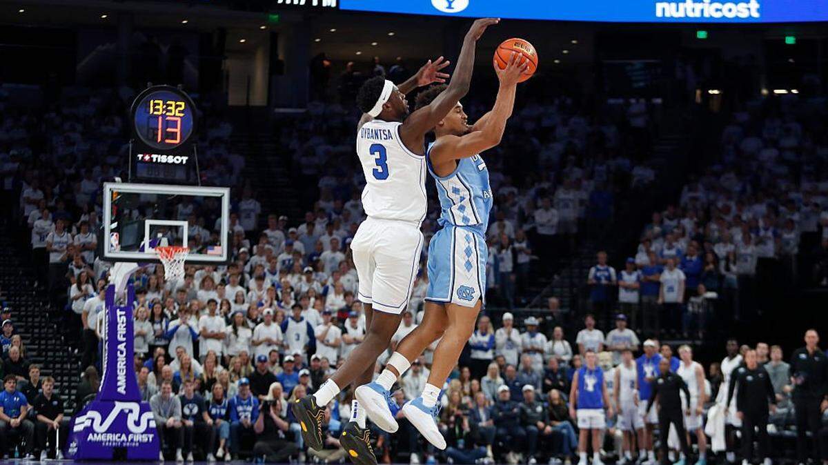 Seth Trimble (7) of North Carolina grabs a high pass away from AJ Dybantsa (3) of BYU during the first half of their exhibition game at the Delta Center on October 24, 2025 in Salt Lake City, Utah.