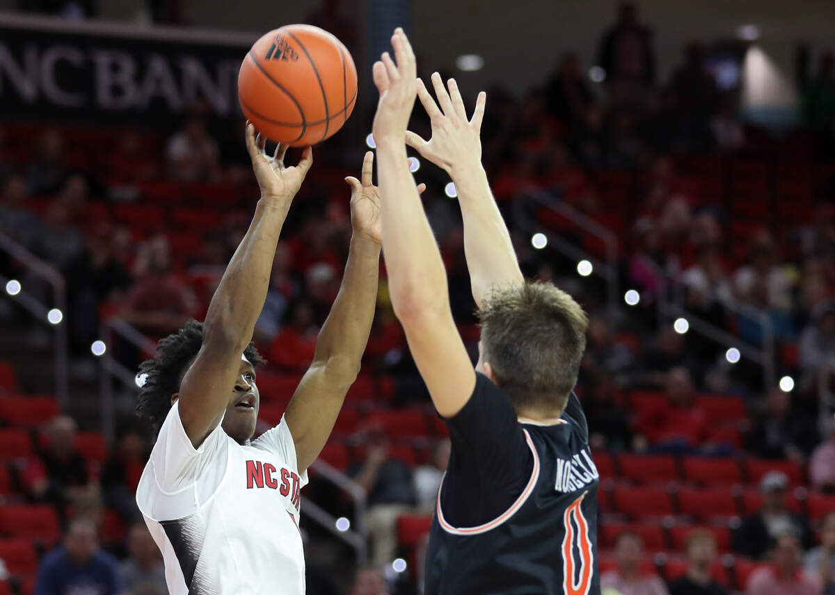 North Carolina State’s Jarkel Joiner shoots over Campbell’s Gediminas Mokseckas to put the Wolfpack up by four points with just over a minute remaining during the second half of a men’s basketball game at PNC Arena in Raleigh, N.C. on Friday, Nov. 11, 2022.