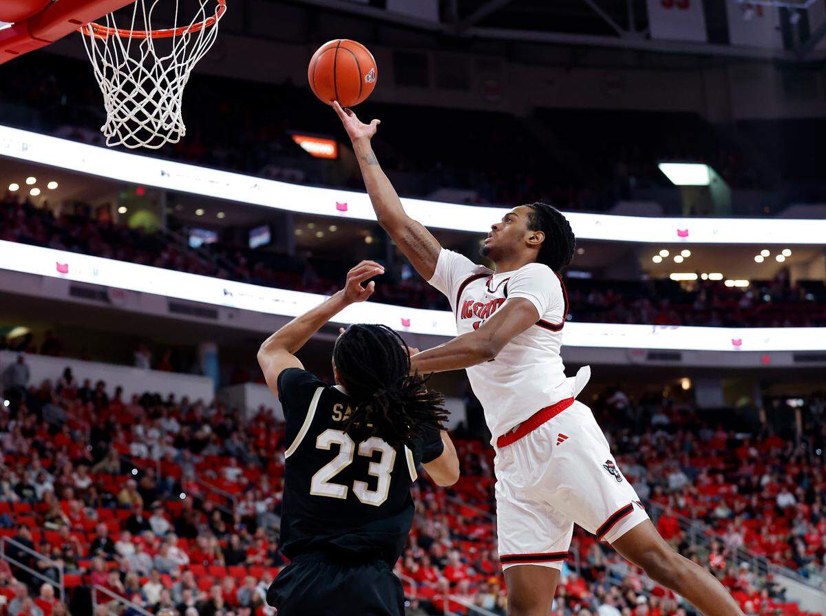 N.C. State’s Dennis Parker Jr. drives to the basket past Wake Forest’s Hunter Sallis during the second half of the Wolfpack’s 85-73 win on Saturday, Feb. 22, 2025, at Lenovo Center in Raleigh, N.C. 