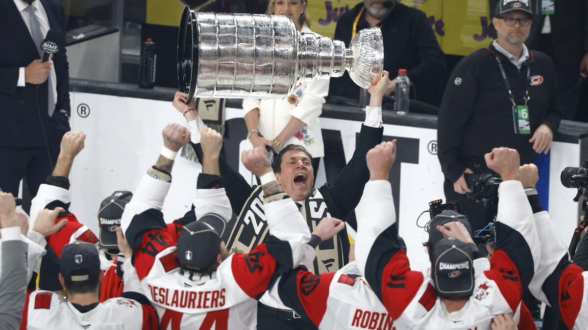 Canes coach Rod Brind'Amour raises the cup after the Hurricanes’ 3-0 victory over the Vegas Golden Knights to win the Stanley Cup at T-Mobile Arena in Las Vegas, Nev., Sunday, June 14, 2026.