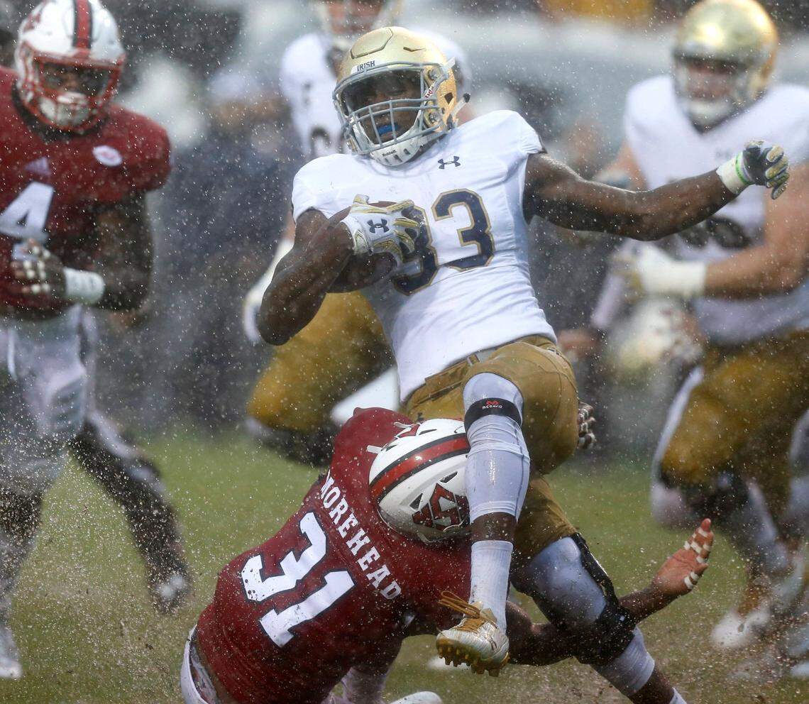 Notre Dame running back Josh Adams (33) is tackled by N.C. State safety Jarius Morehead (31) during the first half of the Wolfpack’s game against Notre Dame at Carter-Finley Stadium in Raleigh, N.C., Saturday, Oct. 8, 2016.