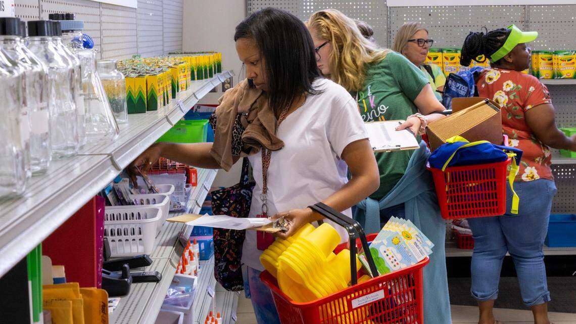 Latricia Webb, foreground, a fourth-grade teacher at Dillard Drive Elementary School, searches for classroom supplies at the Tools4Schools store in Cary Tuesday, Aug 22, 2023. Tools4Schools provides free classroom supplies for teachers in the Wake County school district.