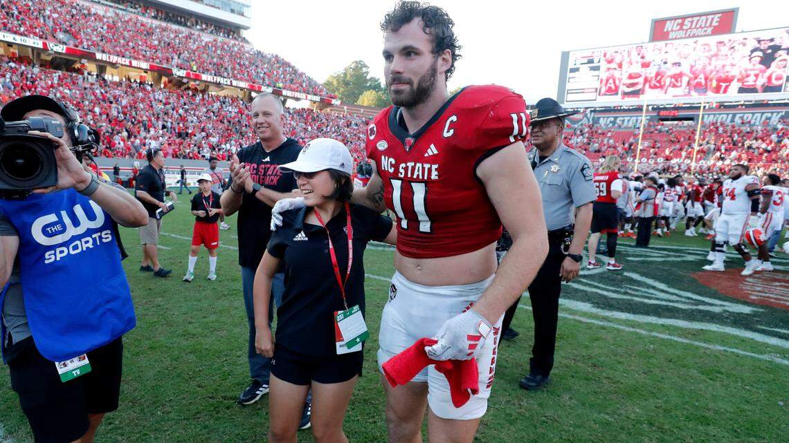 N.C. State linebacker Payton Wilson (11) gives Payton Gibbs a hug after N.C. State’s 24-17 victory over Clemson at Carter-Finley Stadium in Raleigh, N.C., Saturday, Oct. 28, 2023.