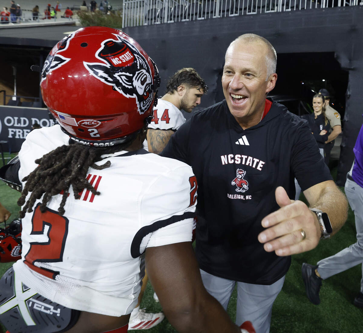 N.C. State head coach Dave Doeren hugs Ronnie Royal III (2) after N.C. State’s 34-24 victory over Wake Forest at Allegacy Stadium in Winston-Salem, N.C., Thursday, Sept. 11, 2025.
