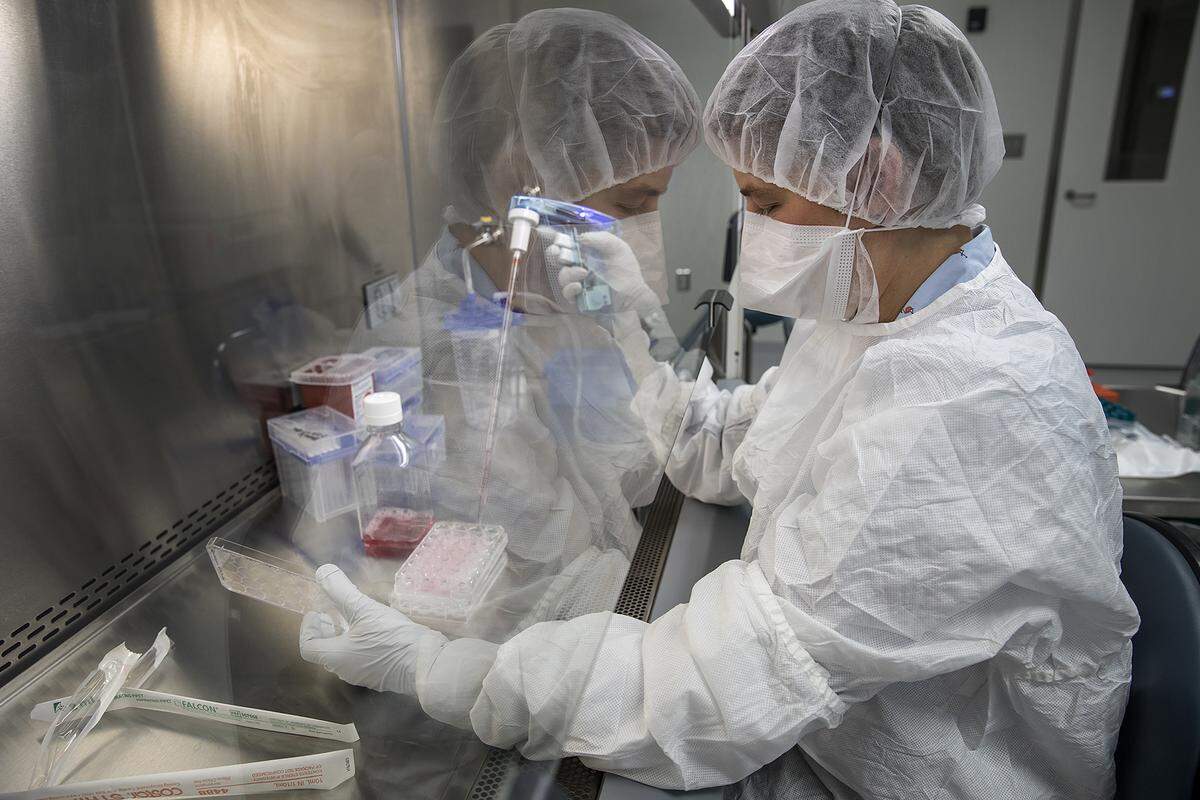 A technician works at UNC Lineberger’s advanced cellular therapeutics facility, which is where chimeric antigen receptor T-cell immunotherapy is developed specifically for a person’s cancer.
