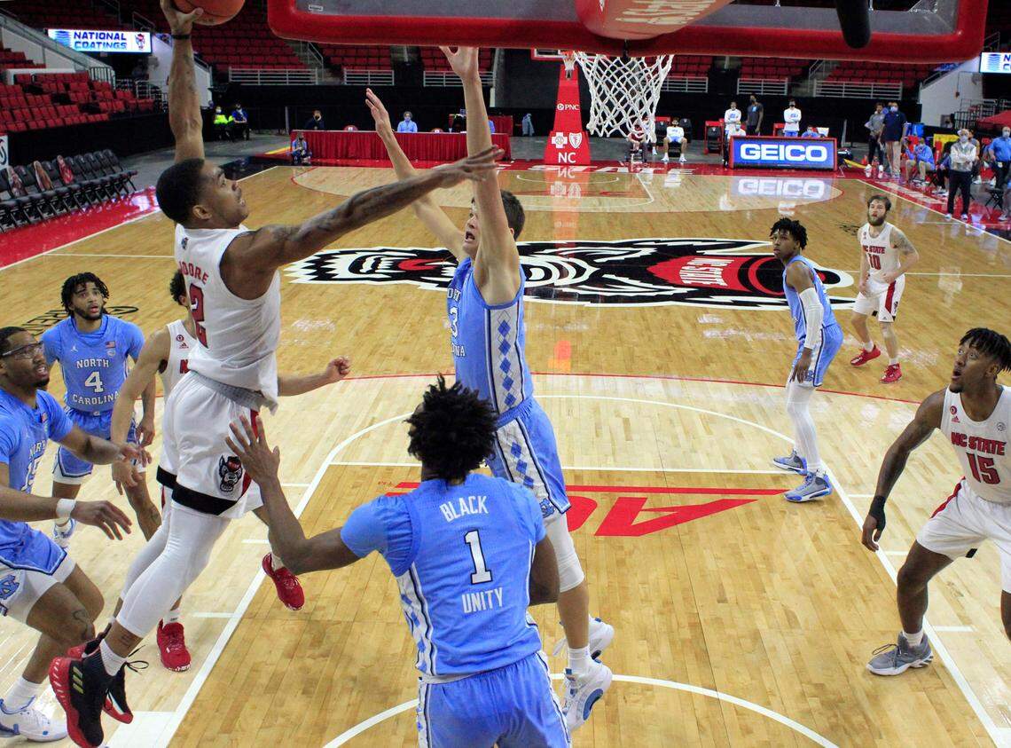 N.C. State’s Shakeel Moore (2) heads to slam in two during N.C. State’s 79-76 victory over UNC at PNC Arena in Raleigh, N.C., Tuesday, December 22, 2020.
