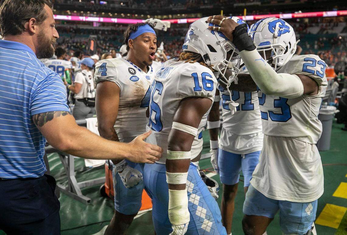 North Carolina defensive back DeAndre Boykins (16) celebrates with teammate Power Echols (23) after Boykins’ interception of Miami quarterback Tyler Van Dyke with eight seconds to play to secure the Tar Heels’ 27-24 victory on Saturday, October 8, 2022 at Hard Rock Stadium in Miami Gardens, Florida.