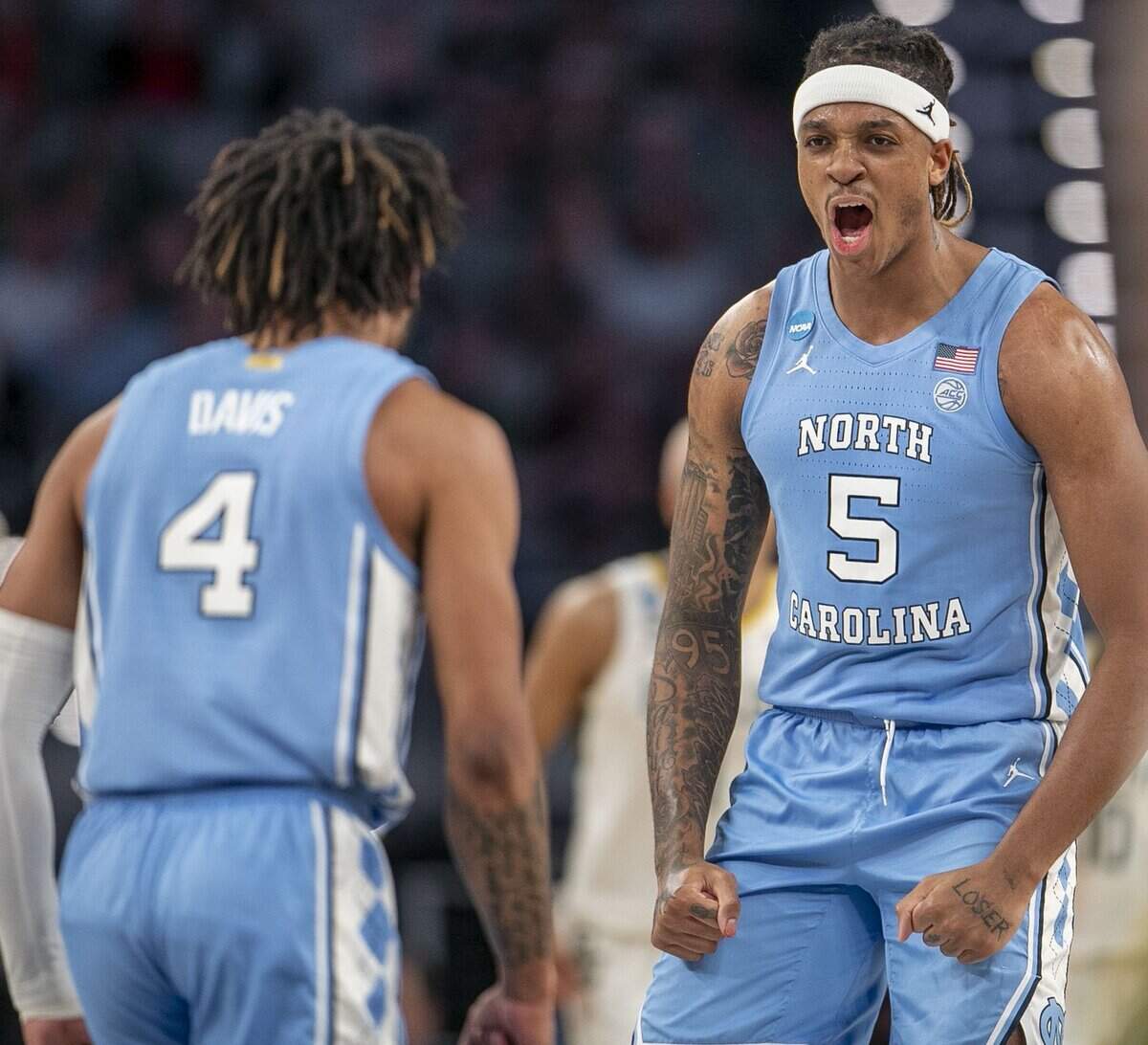 North Carolinas Armando Bacot (5) and R.J. Davis (4) react after a basket by Brady Manek to give the Tar Heels a commanding 56-38 lead over Baylor in the second half on Saturday, March 19, 2022 during the NCAA Tournament at Dickies Arena in Ft. Worth, TX.