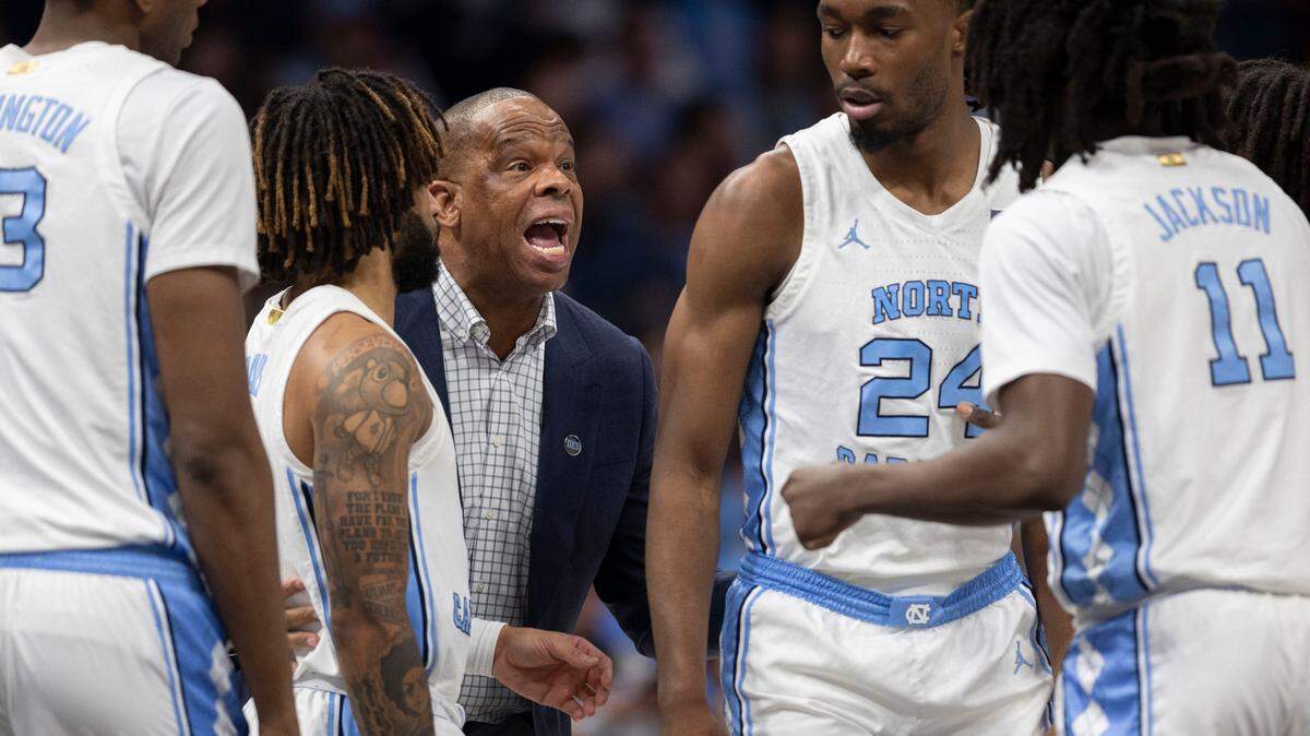 Down by 12 points against Florida, North Carolina coach Hubert Davis huddles with his players during a time out on Tuesday, December 17, 2024 at the Spectrum Center in Charlotte, N.C.