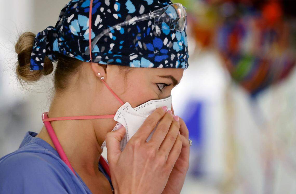 Erica South, a nurse in the emergency department at UNC REX Hospital, tightly positions her N-95 mask. Masking is one of the most effective ways to prevent TB infections.