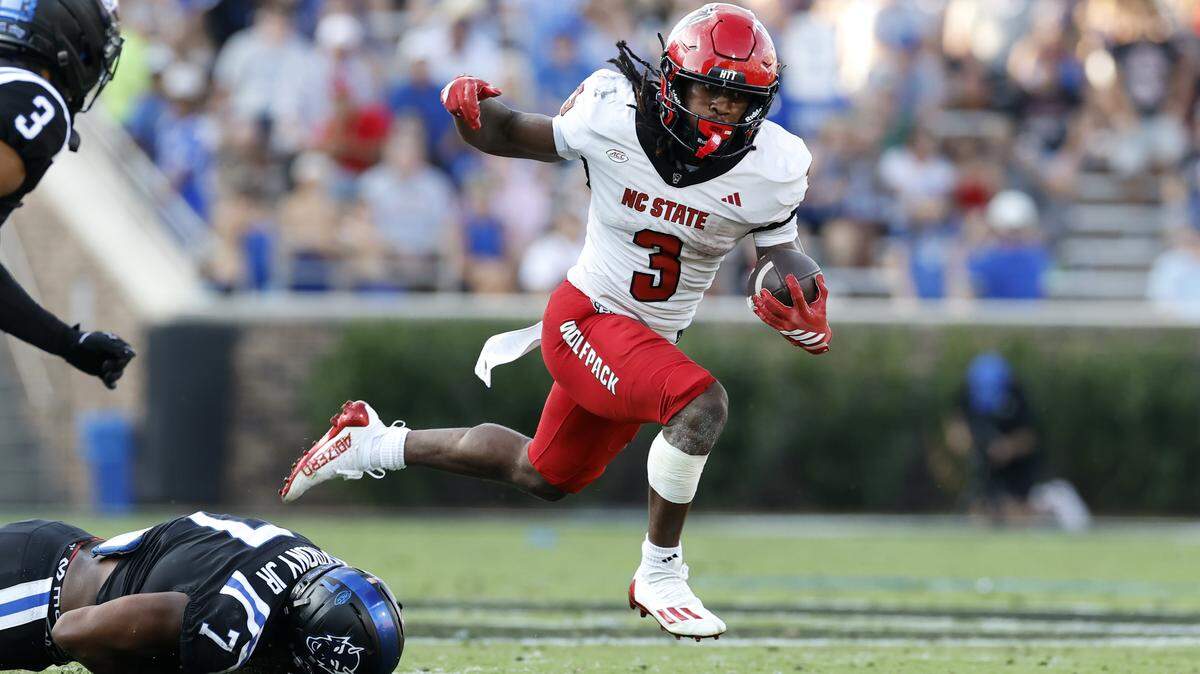 N.C. State running back Hollywood Smothers (3) avoids the tackle by DukeÕs Vincent Anthony Jr. (7) to gain yards during the first half of N.C. StateÕs game against Duke at Wallace Wade Stadium in Durham, N.C., Sat. Sept. 20, 2025