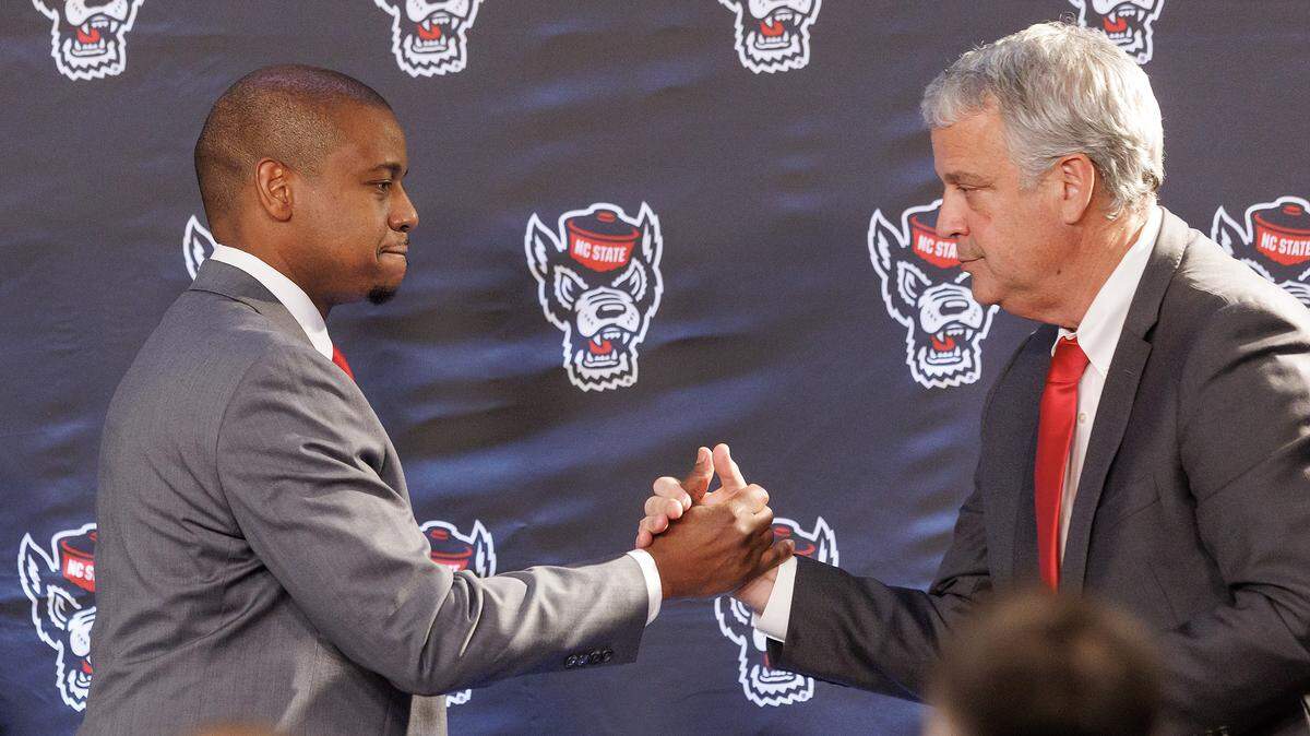 New N.C. State men’s basketball head coach Justin Gainey shakes hands with Athletic Director Boo Corrigan at the start of a press conference at Lenovo Center on Wednesday, April 1.