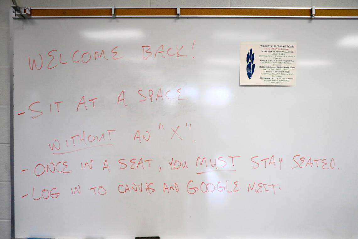 Instructions for returning students are written on a white board in the physical science blended class at Millbrook High School Wednesday morning, February 17, 2021. Wednesday is the the first day of face-to-face classes since March 2020 for Wake County high school students.