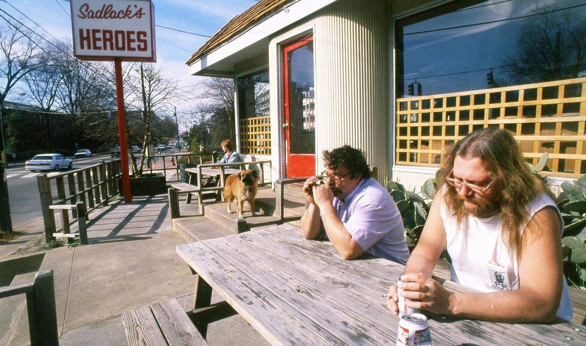On a quiet Saturday afternoon at Sadlack’s on Raleigh, N.C.’s Hillsborough Street in January,1989, Mark Levkoff plays the harmonica while Bobby Hocutt sits and listens.