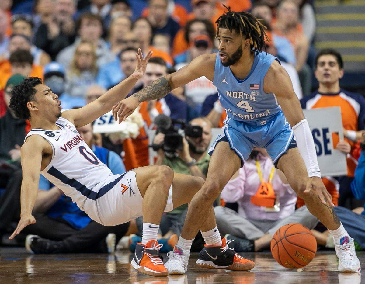 North Carolina’s R.J. Davis (4) collides with Virginia’s Kihei Clark (0) during the first half during the third round of the ACC Tournament on Thursday, March 9, 2023 at the Greensboro Coliseum in Greensboro, N.C.
