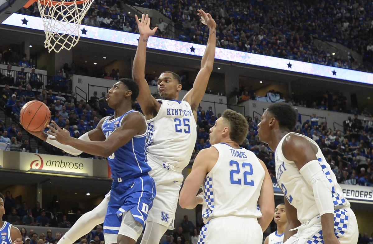 Duke forward R.J. Barrett (5) goes in to score in the first half with a host of Kentucky  defenders at the Bankers Life Fieldhouse in Indianapolis, Indiana, Tuesday, Nov. 6, 2018.